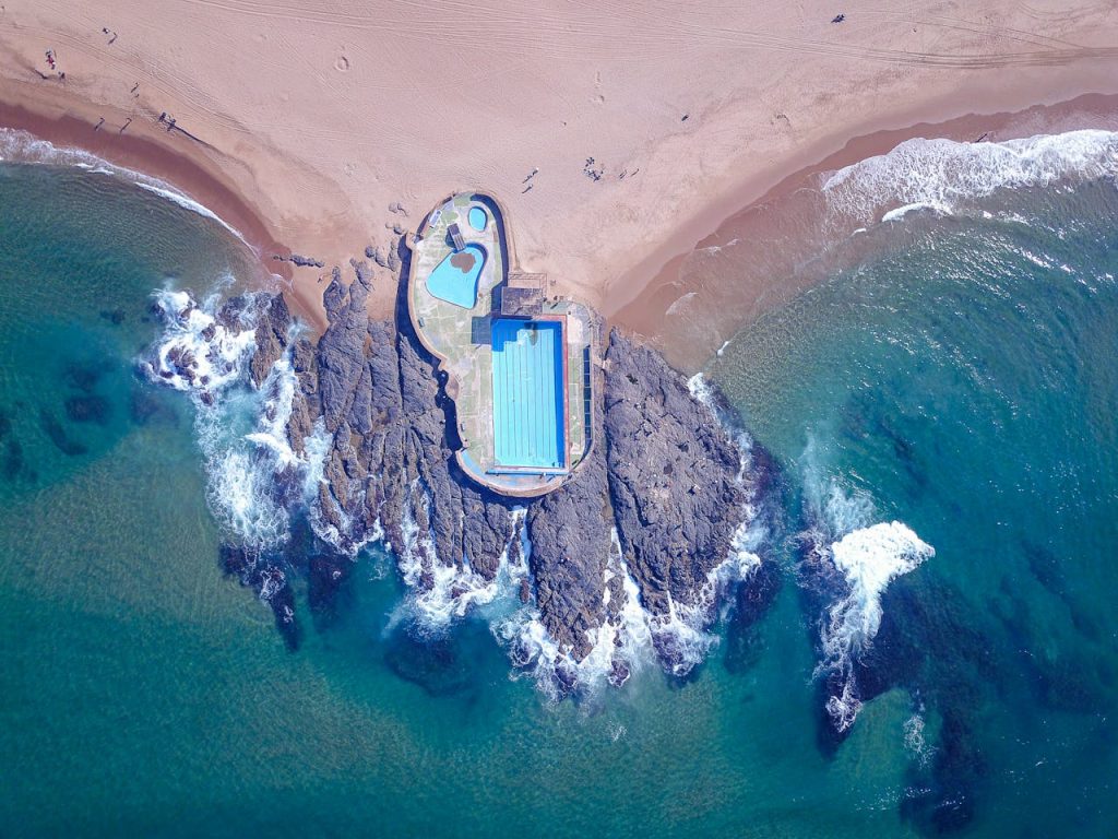 Drone shot of ocean pool at Amanzimtoti beach capturing waves and shoreline